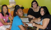 group of teenaged girls sitting at a school table