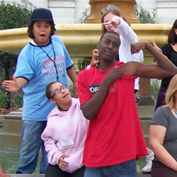 Youth standing in front of a fountain
