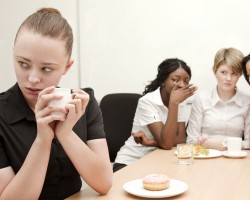 three teenage girls making fun another girl
