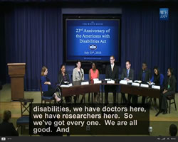 A panel of young people sitting at a table. Closed caption reads: "...disabilities, who have doctors here, we have researchers here. So we've got every one. We are all good. And..."