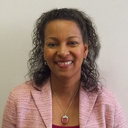 Head and shoulders photo of Patricia D. Gill in a pink blazer