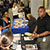 An employer at a job fair talks with potential new hires, some of whom may have disabilities.