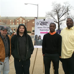 two young men standing next to their fathers